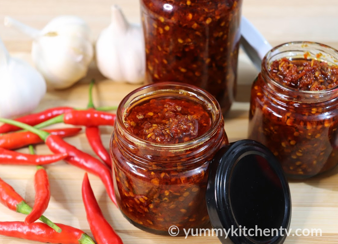 spicy-sweet-chili-sauce-in-a-jar-with-a-spoon-pouring-some-sauce-into