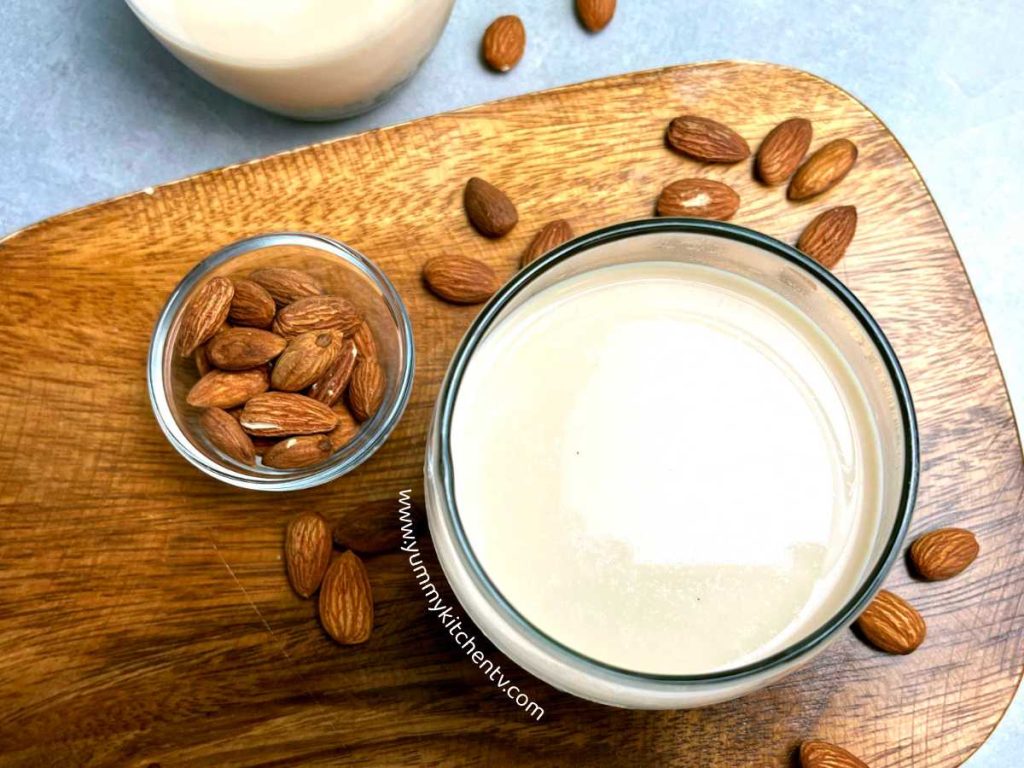 almond milk in a glass with almond nuts